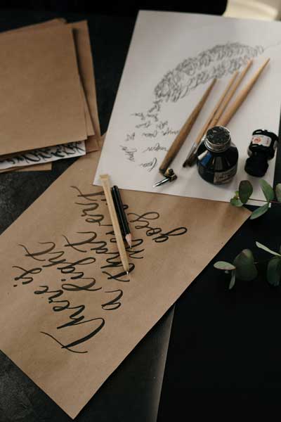 pexels-cottonbro-studio-3826651,Pen and ink bottles caligraphic script